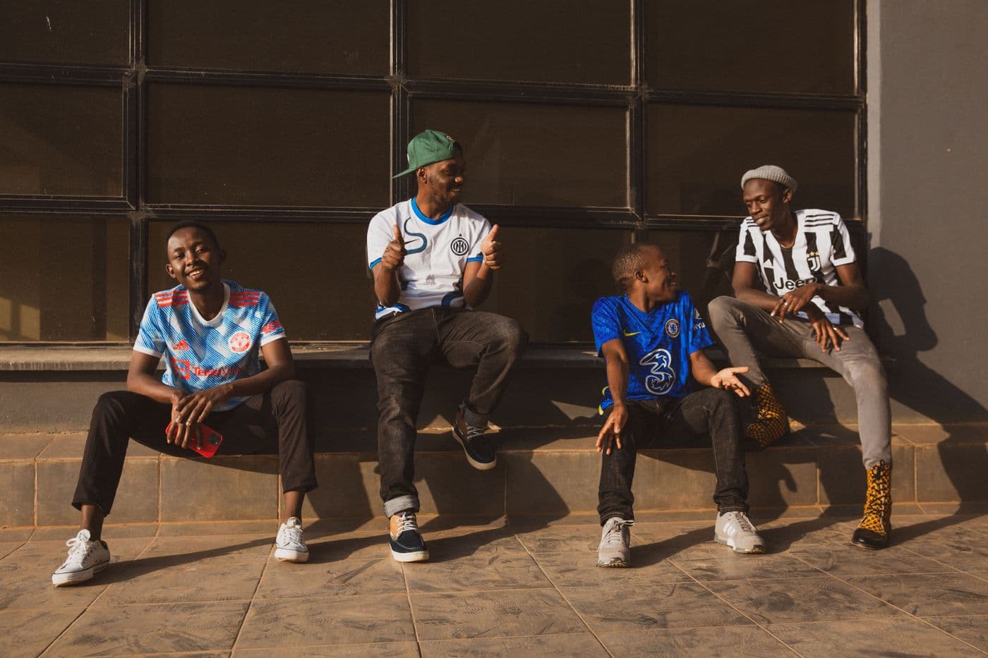 A group of friends sharing a cheerful moment outside a building in Kenya